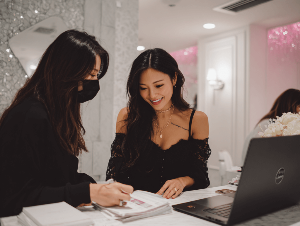 Client consulting with lash expert to choose the perfect lash extensions for small or monolid eyes